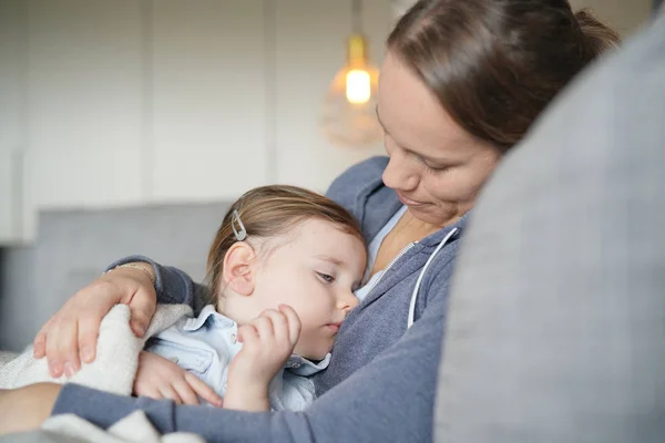 Mother Comforting Her Sleepy Young Daughter Sofa Home — Stock Photo, Image