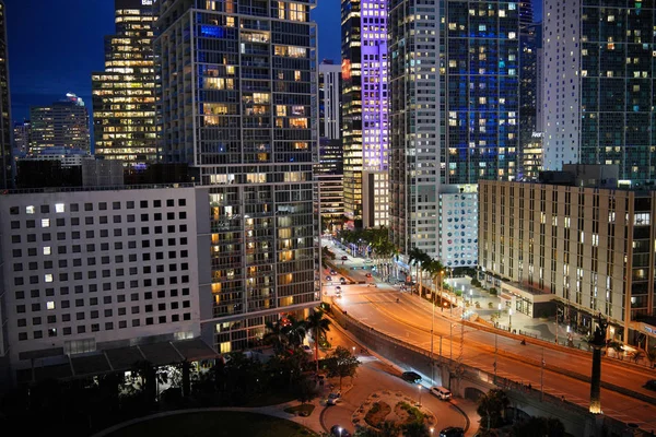 Stunning city lights at night fall on downtown modern buildings