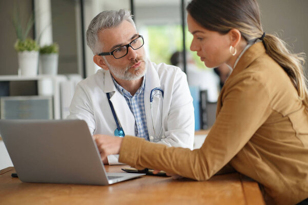 Woman having medical appointment with doctor in hospital