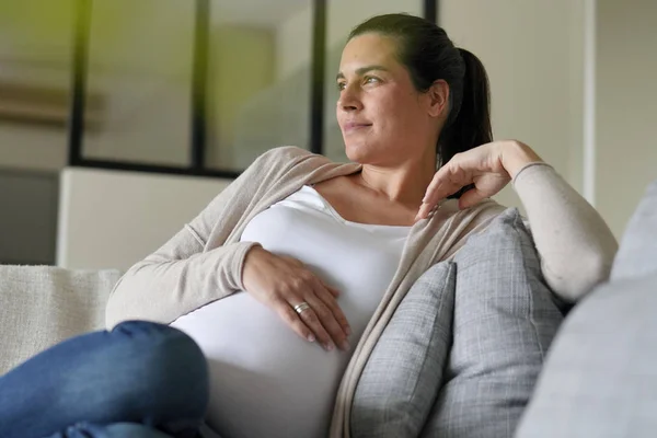 Portrait of pregnant woman relaxing in sofa