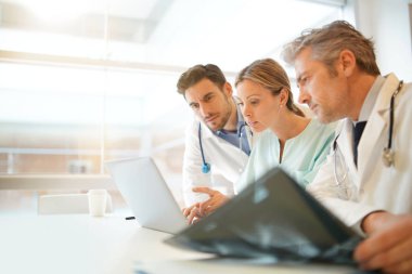 Hastanede hastanın sonuçları üzerinde gidiyor doktorlar ve hemşire