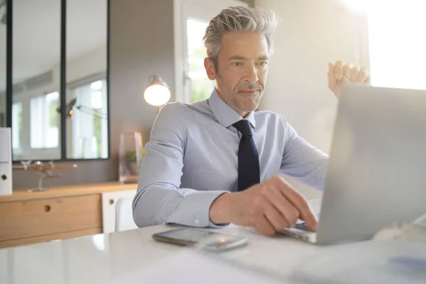 Handsome businessman working in contemporary office