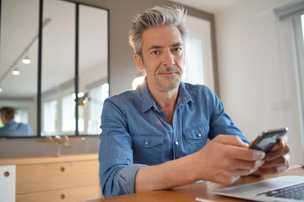 Mature Man Working Home Smiling Camera — Stock Photo, Image