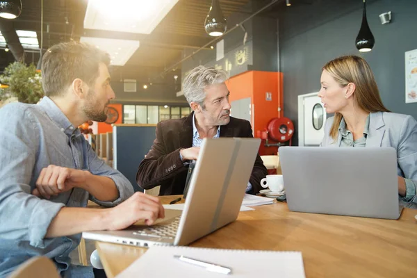 Mixed sales team preparing pitch on work trip