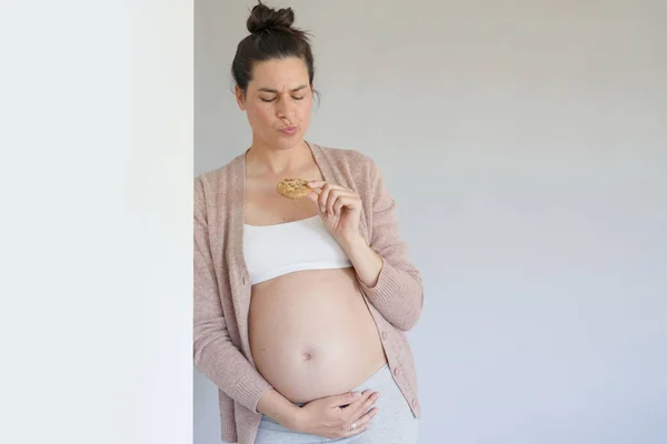 Pregnant Woman Eating Cookie Isolated — Stock Photo, Image