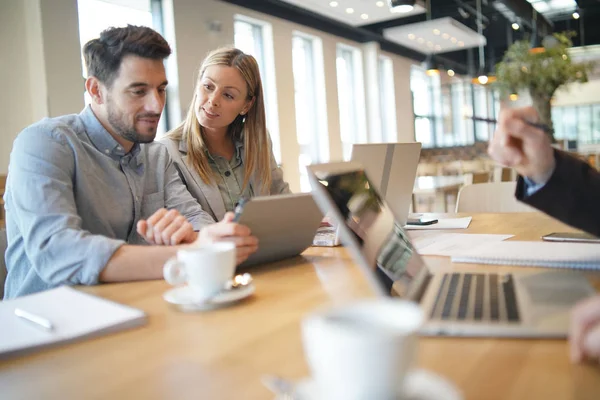 Mixed sales team preparing pitch on work trip