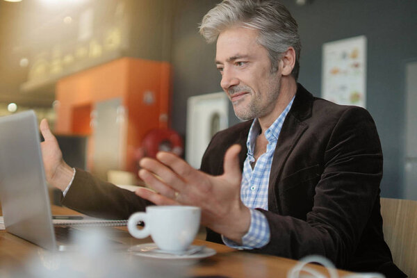 Mature salesman preparing sales pitch