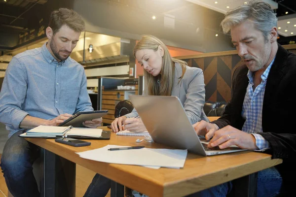 Casual sales team working through presentation with manager