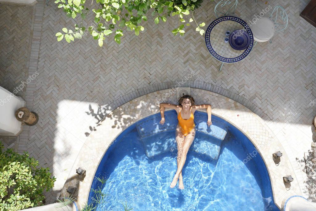 Stunning woman in beautiful moroccan pool