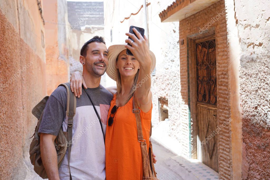 Couple taking selfie in side street in Marrakech