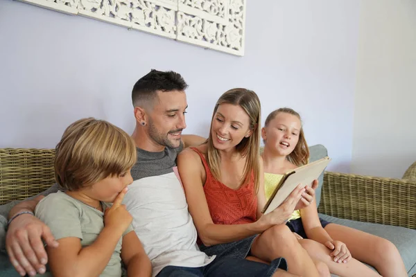 Family of 4 connected on digital tablet