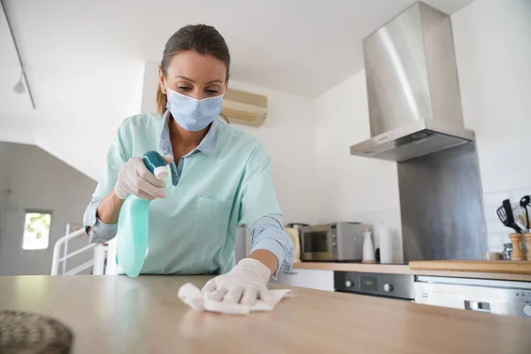 Cleaning woman working with protection mask and gloves