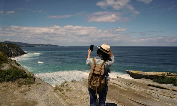 Woman Walking Ocean Coast Wearing Hat Using Smartphone — Stock Photo, Image