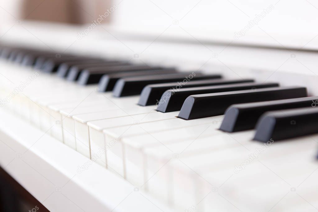 Close up of black and white piano keys. Shallow deep of field.