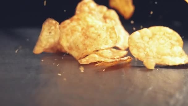 Crunchy roasted potato chips falling on surface — Stock Video