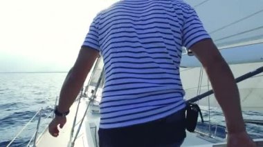 Onun Yelkenli Yat önüne yürüyen adam.