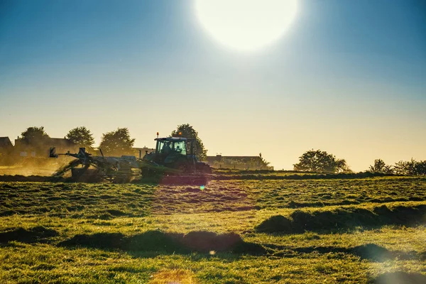 Traktor Agicultural Arbetsmaskiner Solig Vårdag Ett Fält Med Gräs Solnedgång — Stockfoto