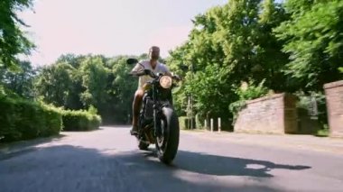 Modern özel scrambler motosiklet sürme - sollama ve eylemleri oyma bir orman yolu üzerinde. Bir motosiklet Tur yolculuğa boş yol sürüş eğleniyor. 4k Video.