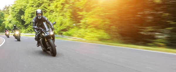 motorbikes riding on the empty road 