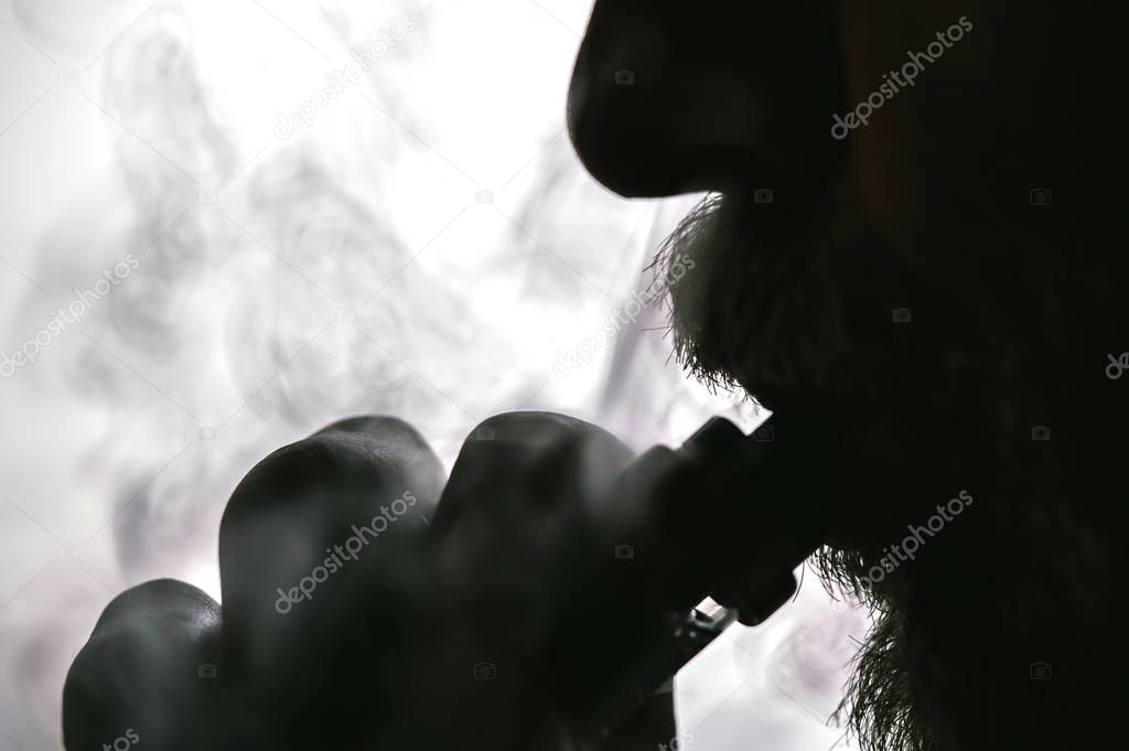 Man with concealed identity smoking a controversial vape is a he