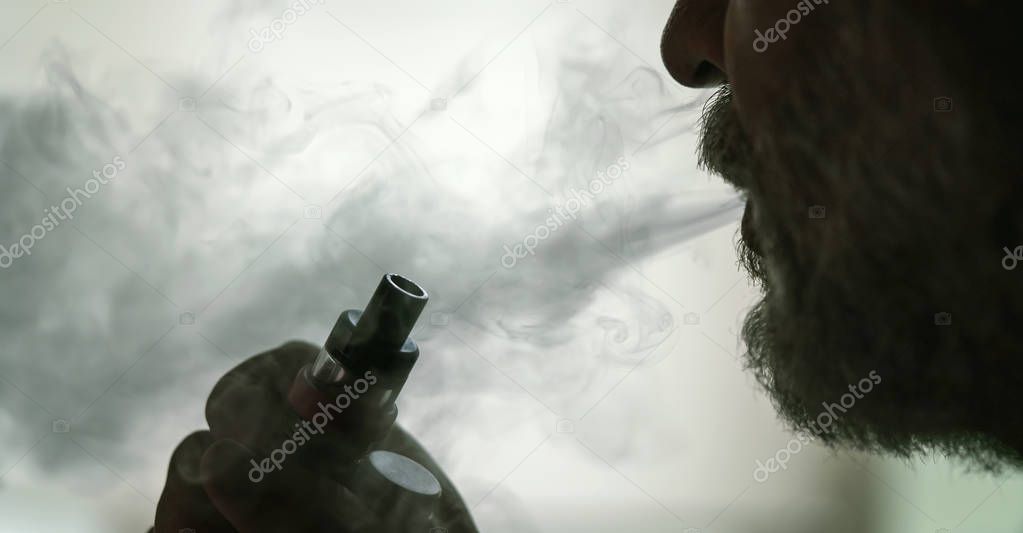 Man with concealed identity smoking a controversial vape is a he