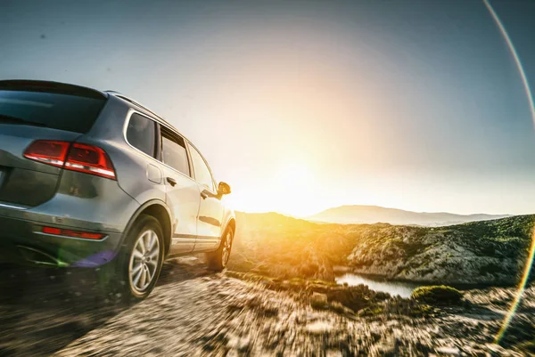 SUV car in spain mountain landscape road at sunset — ストック写真