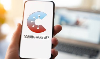 Aaachen / Germany, June 18 2020: Apple iphone with official corona app of the german goverment clipart