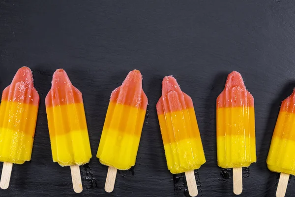 Lime Orange Ice Cream Stick Black Slate Board Focus Popsicles — Stock Photo, Image