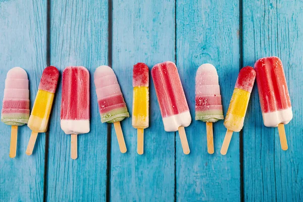 Ice cream stick placed on a blue vintage wooden — Stock Photo, Image