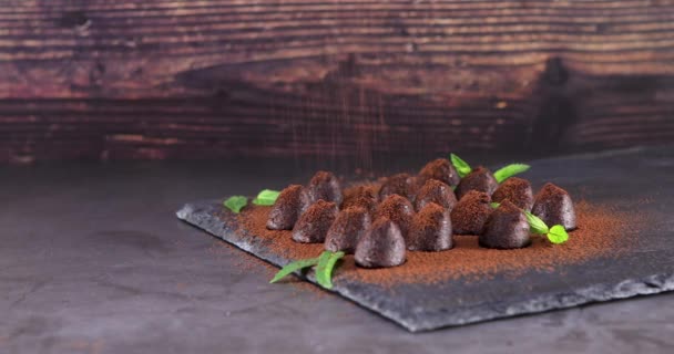 Sprinkling Cocoa Delicious Chocolate Truffles Slate Dolly Shot — Stock Video