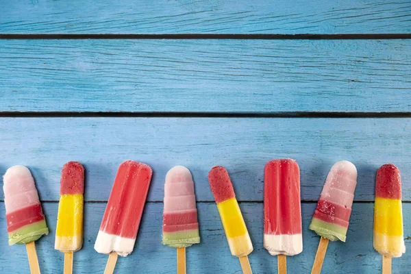 Ice cream stick placed on a blue vintage wooden — Stock Photo, Image
