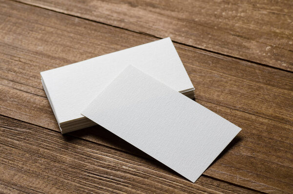 white blank business card on a wooden background