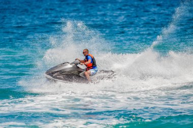 Young Man on Jet Ski, Tropical Ocean, Vacation Concept clipart