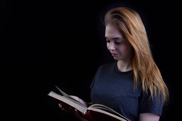 Young Girl Reading Book Black Background ロイヤリティフリーのストック写真