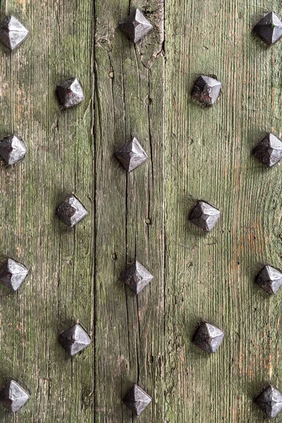 Detail from old wooden door with ancient metal rivets — Stock Photo, Image