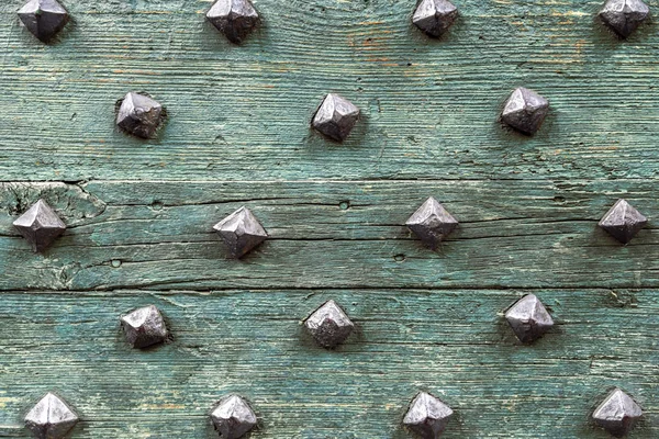 Detail from old wooden door with ancient metal rivets — Stock Photo, Image