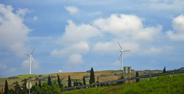 Wind power stations in the desert of Tunisia and landscape against cloudy sky