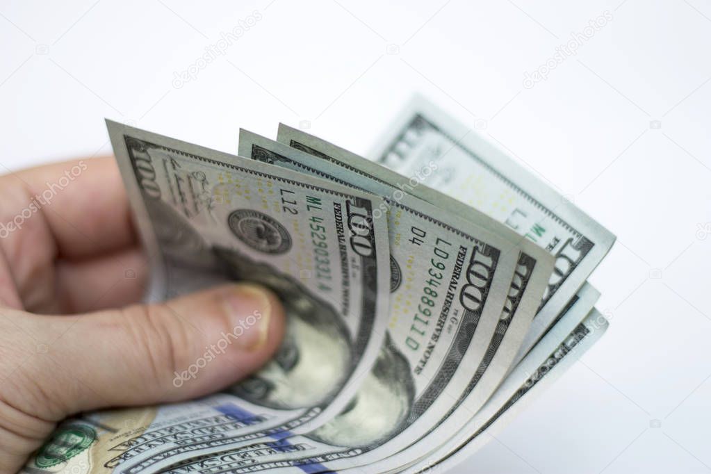 Man paying by Stack Of Paper Dollars Usa On The White Background