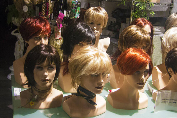 Wigs on a mannequins in a shop window