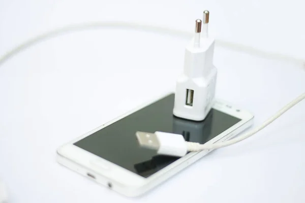 Smartphone and phone charge with power cord — Stock Photo, Image