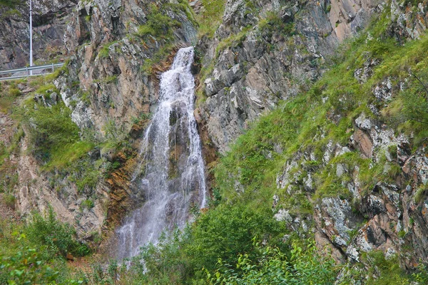 Waterfall flowing down between a caucasus mountains of North Cau — Stok fotoğraf