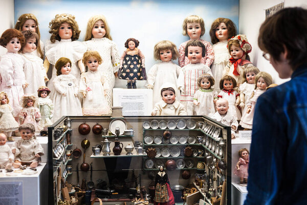 MUNICH, GERMANY - MAY 24, 2018: visitor views of dolls in Spielzeugmuseum (Toy Museum) in tower of Old Town Hall (Alten Rathausturm). The Munich Toy Museum was opened by Ivan Steiger in 1983