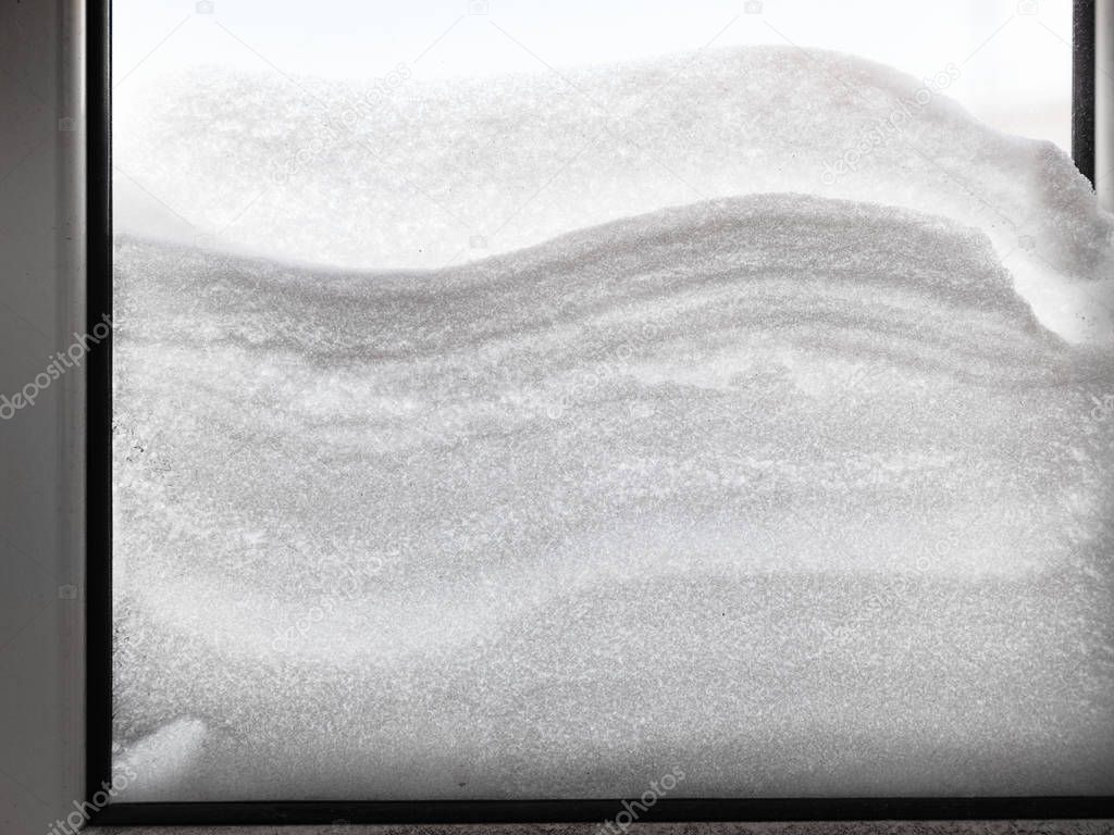 snowdrift between two window panes in winter day