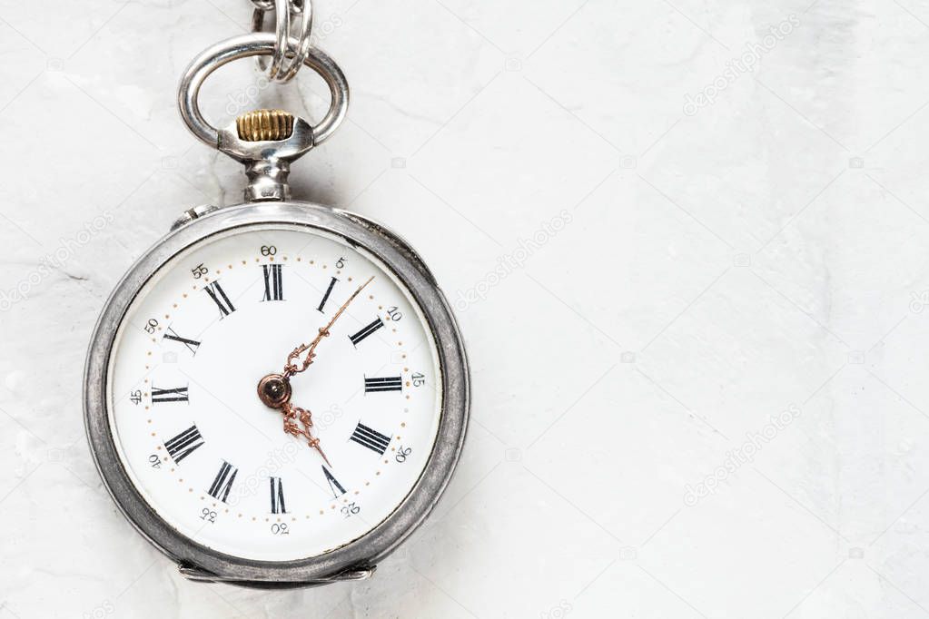 retro pocket watch on light gray plaster background