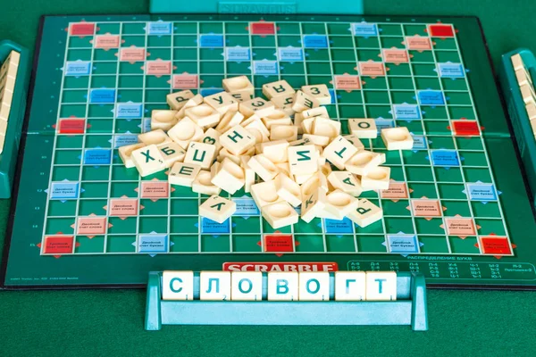 Pile of letter tiles on board of Scrabble game — Stock Photo, Image