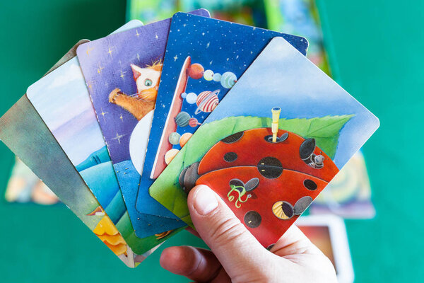 player shows picture cards during Dixit board game