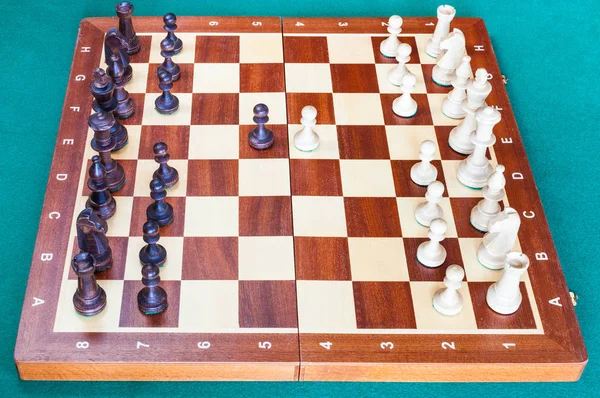 Wooden chessboard with first chess pawn moves — Stock Photo, Image