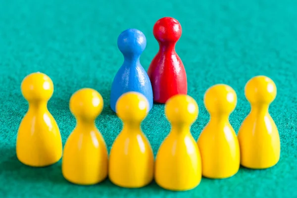 Blue and red pawns in front of yellow pawns — Stock Photo, Image