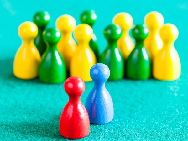Blue and red pawns in front of other color pawns — Stock Photo, Image