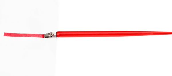 Side view of dip pen drawing red line by wide nib — Stock Photo, Image